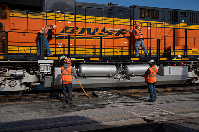 Employees clean a locomotive in San Bernardino, California. Employees clean a locomotive in San Bernardino, California.